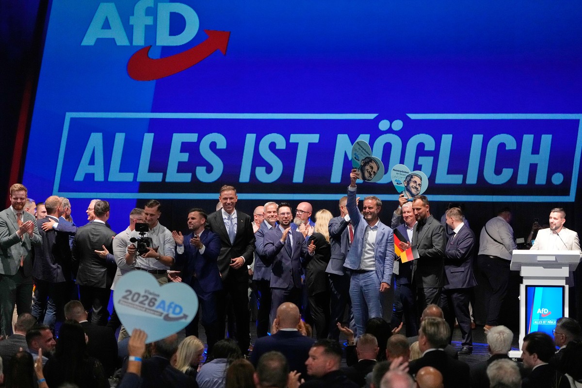 AfD party members celebrate in front of a reading "everything is possible" after the first results at an election party of the "Alternative for Germany" (AfD) after the Saxony-Anha ...
