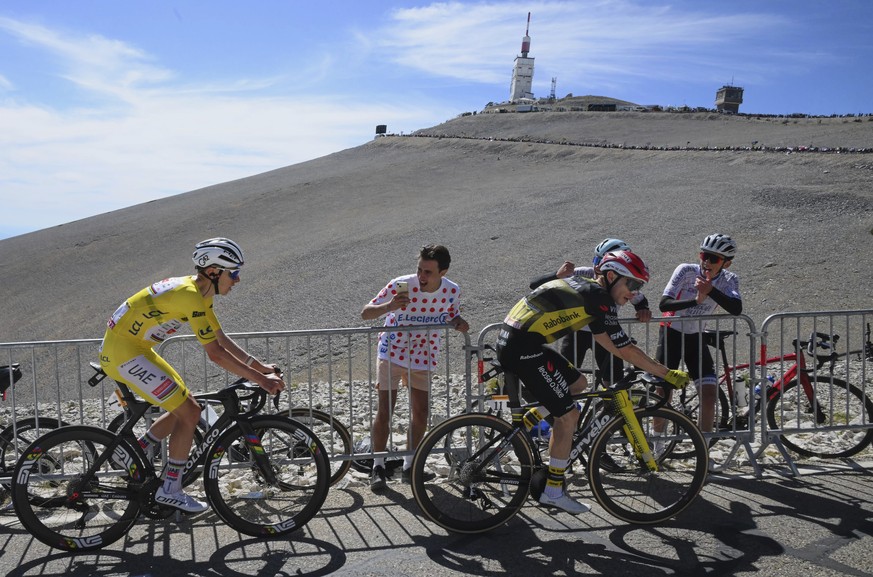 Slovenia&#039;s Tadej Pogacar, wearing the overall leader&#039;s yellow jersey, follows Denmark&#039;s Jonas Vingegaard, as they climb in a Lunar landscape during the last kilometers of the sixteenth  ...