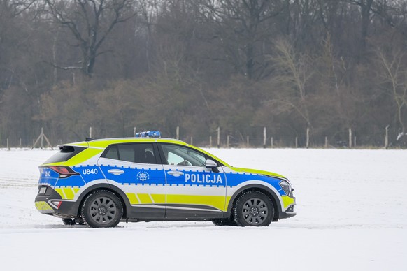 epa11913003 Polish police officers patrol in Sedziny village, west-central Poland, 21 February 2025. Another unidentified object, likely a piece of SpaceX rocket debris, has been discovered in a fores ...