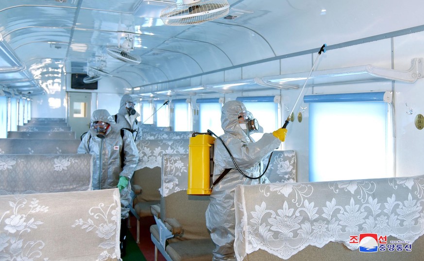 epa08218857 A photo released by the official North Korean Central News Agency (KCNA) shows people spraying disinfectant to combat the Covid-19 and coronavirus in Pyongyang, Democratic People's Re ...