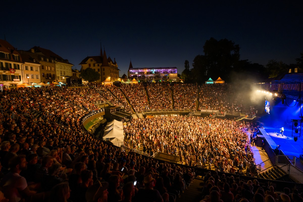 Les festivaliers ecoutent le concert du groupe britannique Status Quo sur la scene des arenes lors de la 30eme edition du Festival Rock Oz'Arenes le mercredi 10 aout 2022 dans l'amphitheatre ...