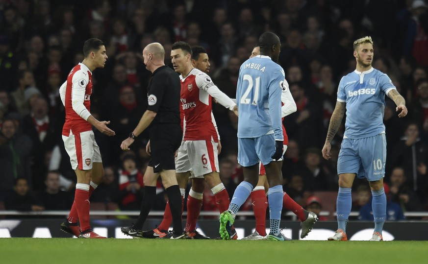 Football Soccer Britain - Arsenal v Stoke City - Premier League - Emirates Stadium - 10/12/16 Arsenal&#039;s Laurent Koscielny and Granit Xhaka remonstrate with referee Lee Mason after a penalty is aw ...