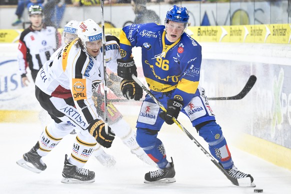 Chris Egli von Davos, rechts, gegen Ryan Wilson von Lugano, beim Eishockey-Qualifikationsspiel der National League A zwischen dem HC Davos und dem HC Lugano, am Freitag, 9. Dezember 2016, in der Vaill ...