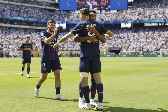 epa12227913 Fabian Ruiz of PSG (R) celebrates scoring the 3-0 goal with teammates Desire Doue (C) and Khvicha Kvaratskhelia (L) during the FIFA Club World Cup 2025 match between Paris Saint-German and ...