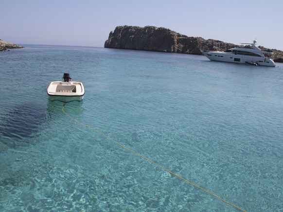 The multihued waters of the Aegean Sea sparkle by the islet of Kounoupa off the island of Astypalea, Greece, on Aug. 30, 2021. (AP Photo/Giovanna Dell