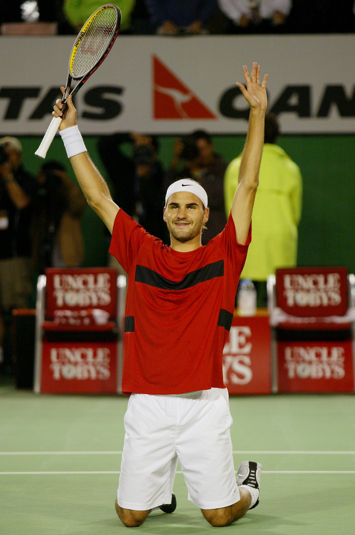 Switzerland's Roger Federer kneels on center court as he waves to the crowd following his semifinal win over Spain's Juan Carlos Ferrero at the Australian Open in Melbourne, Australia, Frida ...
