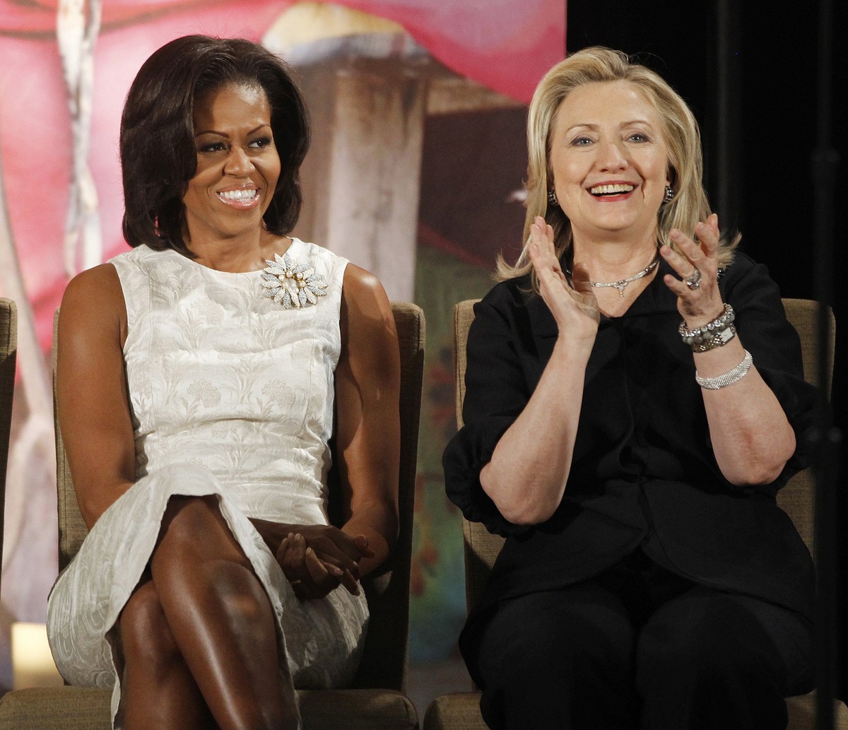 FILE - In this March 8, 2012, file photo, then-Secretary of State Hillary Clinton and first lady Michelle Obama attend the 2012 International Women of Courage Awards at the State Department in Washing ...