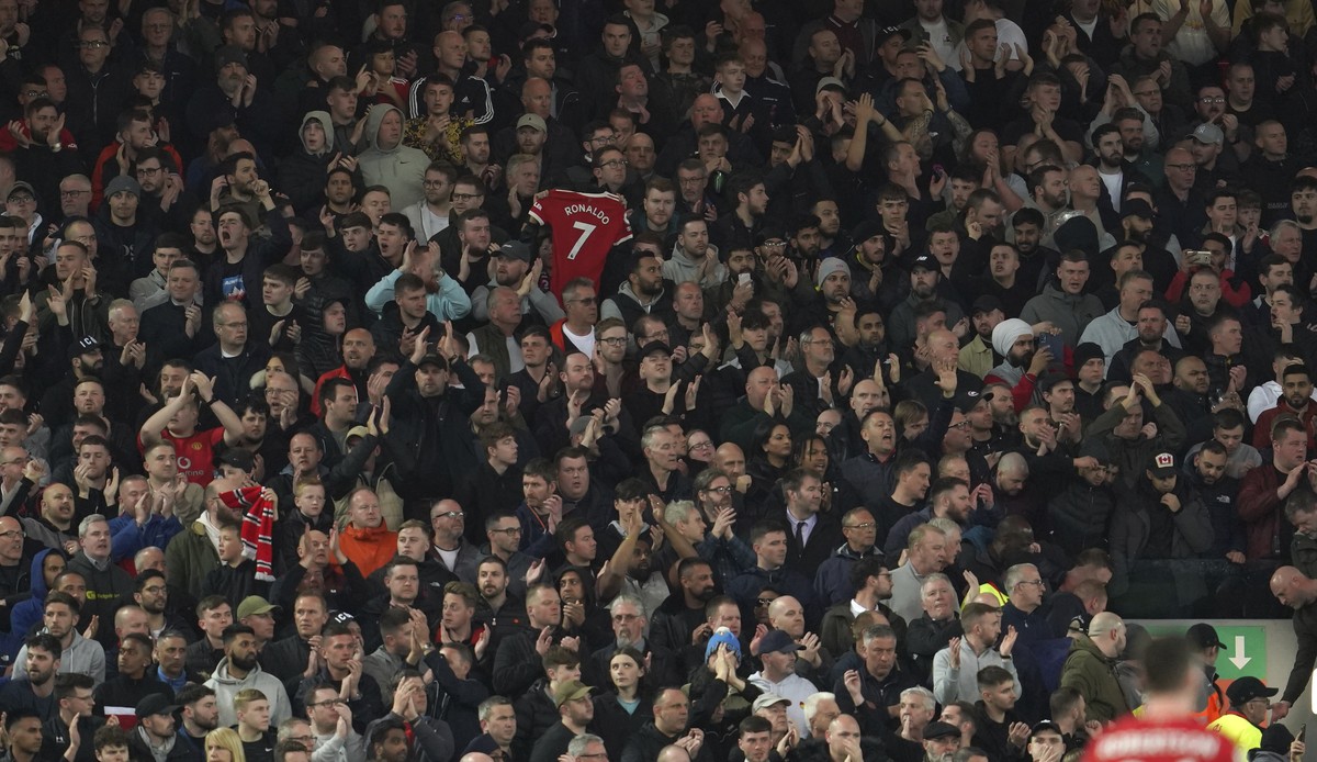 Liverpool fans applaud on the seventh minute in support for Manchester United's Cristiano Ronaldo and his family during the English Premier League soccer match between Liverpool and Manchester Un ...