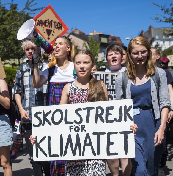 Swedish climate activist Greta Thunberg reacts with other young climate activists during a demonstration against climate change on the closing day of the «' Smile for Future Summit for climate� ...