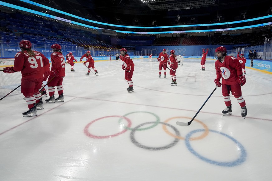 Russian Olympic Committee players warm up before a preliminary round women&#039;s hockey game against Canada at the 2022 Winter Olympics, Monday, Feb. 7, 2022, in Beijing. The players left the ice as  ...