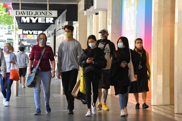 epa08779527 People walk along Bourke Street Mall outside of Myer despartment store in Melbourne, Victoria, Australia, 28 October 2020. Further coronavirus restrictions were eased in metropolitan Melbourne last night.  EPA/JAMES ROSS AUSTRALIA AND NEW ZEALAND OUT