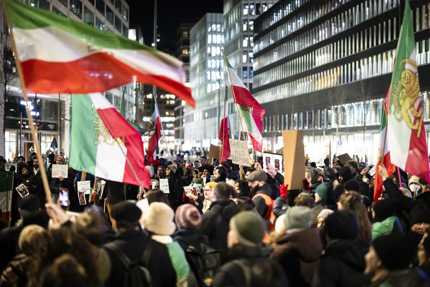 epa12647294 Protesters attend a rally in support of the nationwide mass demonstrations in Iran against the government, in Zuerich, Switzerland, 13 January 2026. Nationwide anti-government protests, tr ...