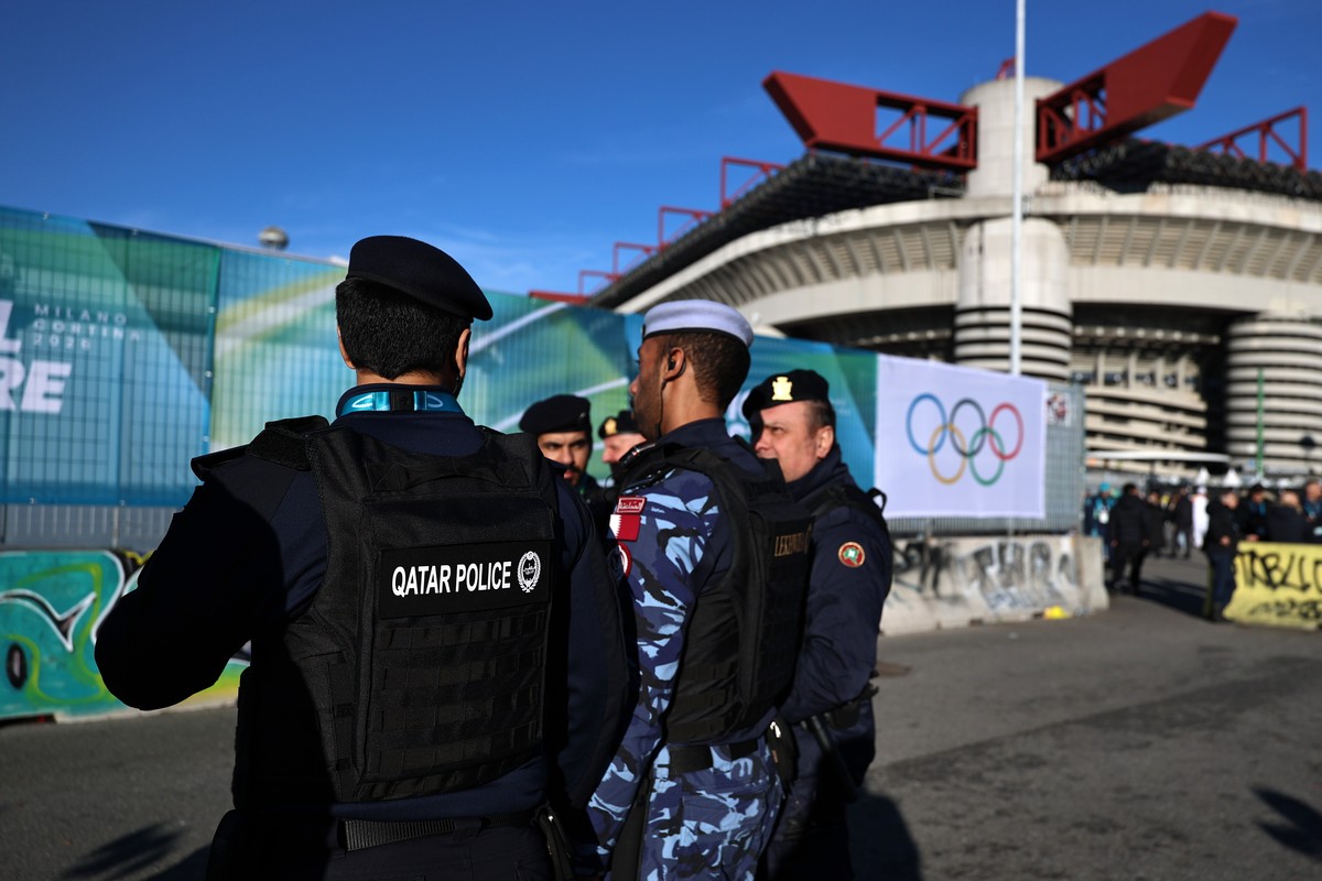 epa12709397 Memebers of the Qatari police, who are in Milan to assist in securing the venue, stand outside of San Siro stadium ahead of the Opening Ceremony of the Milano Cortina 2026 Winter Olympic G ...