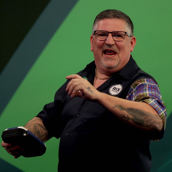 Scotland's Gary Anderson celebrates winning against England's Justin Hood on day eighteen of the World Darts Championship at Alexandra Palace in London, Tuesday Dec. 30, 2025. (Steven Paston ...
