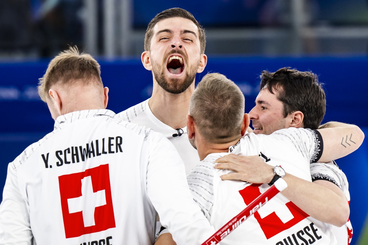 Bronze medalists Yannick Schwaller, Pablo Lachat-Couchepin, Sven Michel and Benoit Schwarz-van Berkel of Switzerland, from left to right, celebrate during the men's curling bronze medal game betw ...