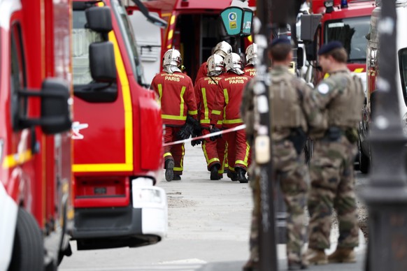 epa07891708 French police and security forces establish a security perimeter near Paris police headquarters after a man has been killed after attacking officers with a knife in Paris, France, 03 Octob ...