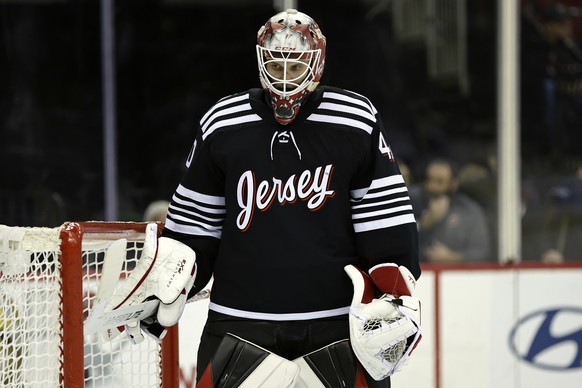 New Jersey Devils goaltender Akira Schmid reacts in the third period of an NHL hockey game against the Dallas Stars on Tuesday, Dec. 13, 2022, in Newark, N.J. The Stars won 4-1. (AP Photo/Adam Hunger) ...