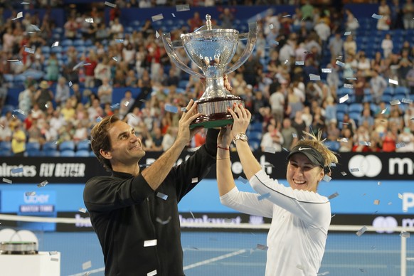 Switzerland&#039;s Roger Federer and Belinda Bencic hold the trophy after winning the final against Alexander Zverev and Angelique Kerber of Germany at the Hopman Cup in Perth, Australia, Saturday Jan ...