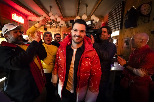 Gold medalist Switzerland's Loic Meillard gets welcomed by staff, family members and riends as he arrives at the House of Switzerland in the Bormio Bar at the 2026 Olympic Winter Games in Bormio, ...