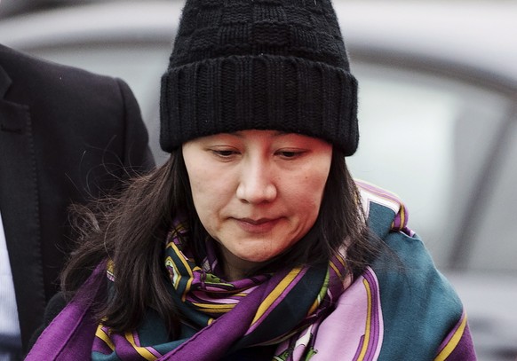 FILE - In this Dec. 12, 2018, file photo, Huawei chief financial officer Meng Wanzhou arrives at a parole office with a security guard in Vancouver, British Columbia. China on Tuesday, Jan. 22, 2019,  ...