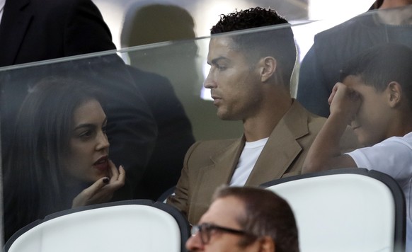 Juventus forward Cristiano Ronaldo and his partner Georgina sit in the stands prior to the Champions League, group H soccer match between Juventus and Young Boys, at the Allianz stadium in Turin, Ital ...