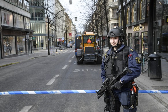 epa05896488 A policeman near the scene of a truck attack in central Stockholm, Sweden, 08 April 2017, the morning after the hijacked beer truck ploughed into pedestrians on Drottninggatan and crashed into Ahlens department store, killing four people, injuring 15 others.  EPA/ANDERS WIKLUND  SWEDEN OUT