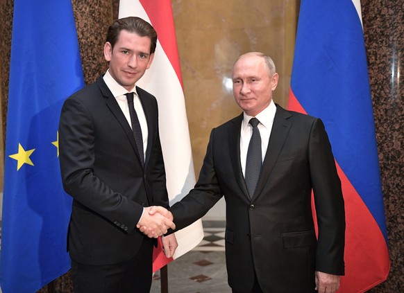 epa07067027 Austria&#039;s Federal Chancellor Sebastian Kurz (L) shakes hands with Russian President Vladimir Putin (R) during their meeting in St.Petersburg, Russia, 03 October 2018. Austrian Chancel ...