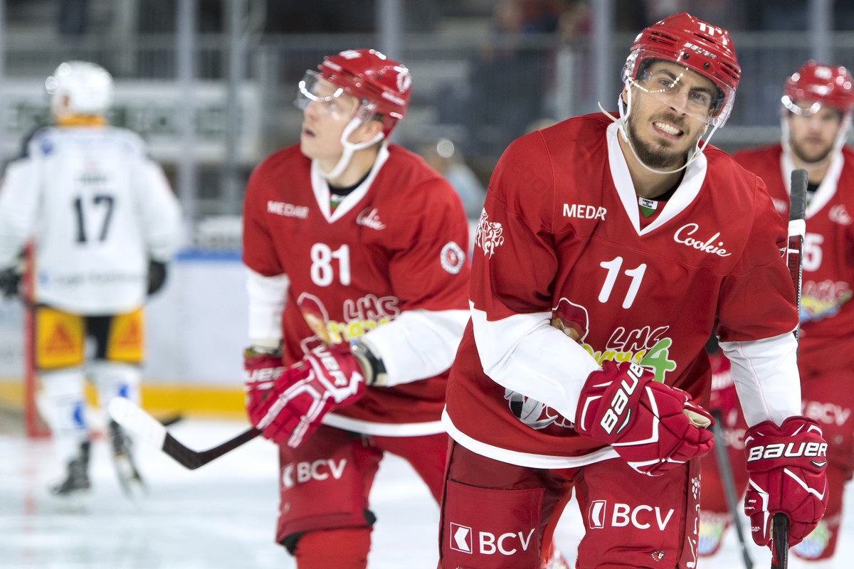 L'attaquant lausannois Yannick Herren, droite, et l'attaquant lausannois Ronalds Kenins, centre, celebrent le 3eme goal lors du match du championnat suisse de hockey sur glace de National Le ...