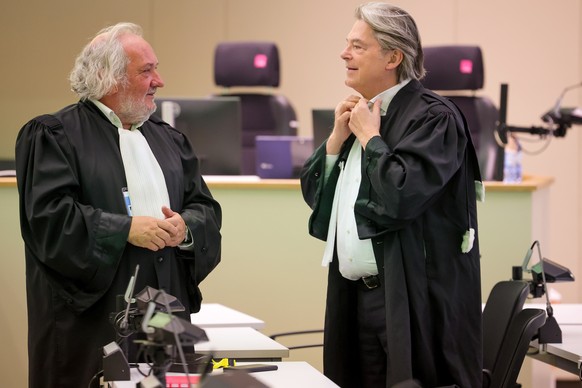 epa10768208 Lawyers Vincent Lurquin (L) and Michel Bouchat talk prior to the beginning of the session of the 2016 Brussels terrorist attack trial in the Palace of Justice, Brussels, Belgium, 25 July 2 ...