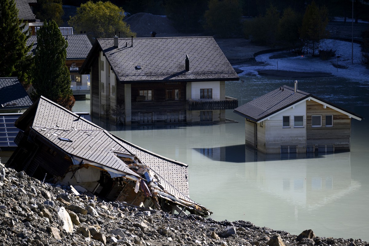 Destroyed and flooded houses are pictured during the groundbreaking ceremony of reconstruction the village, project "Blatten 2030", 3,5 months after a landslide destroyed the village, in Bla ...
