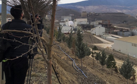 Journalists work next to the Copler gold mine near Ilic village, east Turkey, Tuesday, Feb. 13, 2024. A landslide hit a gold mine in eastern Turkey on Tuesday, apparently trapping at least nine worker ...