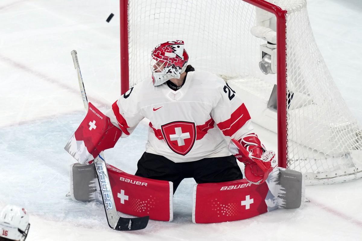 Switzerland goalkeeper Andrea Braendli blocks a shot against Sweden during the third period of the women's ice hockey bronze medal game at the 2026 Winter Olympics, in Milan, Italy, Thursday, Feb ...
