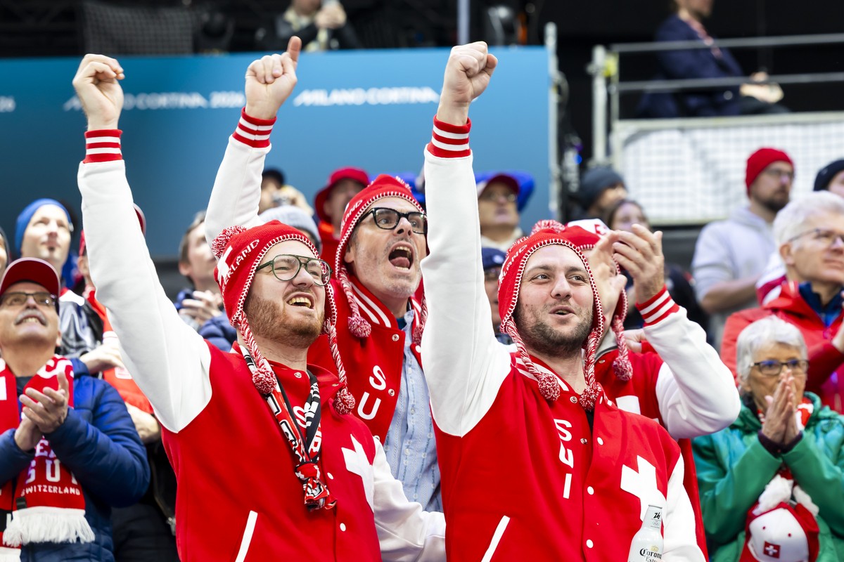 Swiss fans celebrate a Swiss team's goal, during the men's group A preliminary round game between Switzerland and France at the 2026 Olympic Winter Games in Milan Santagiulia Ice Hockey Aren ...