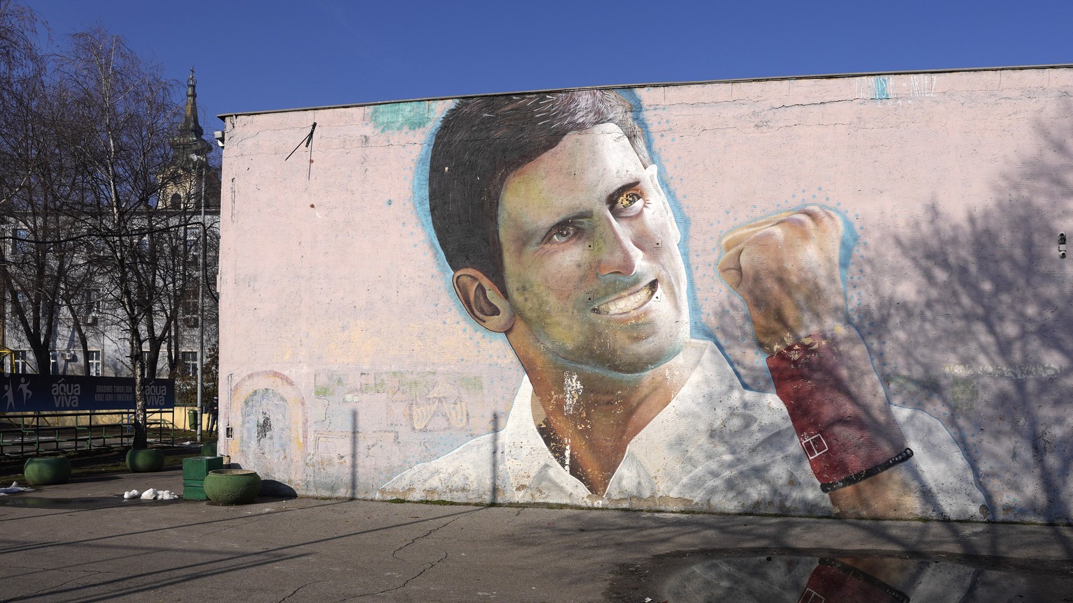 A mural depicting Serbian tennis player Novak Djokovic on a wall in Belgrade, Serbia, Sunday, Jan. 16, 2022. Novak Djokovic was preparing to leave Australia on Sunday evening after losing his final bi ...