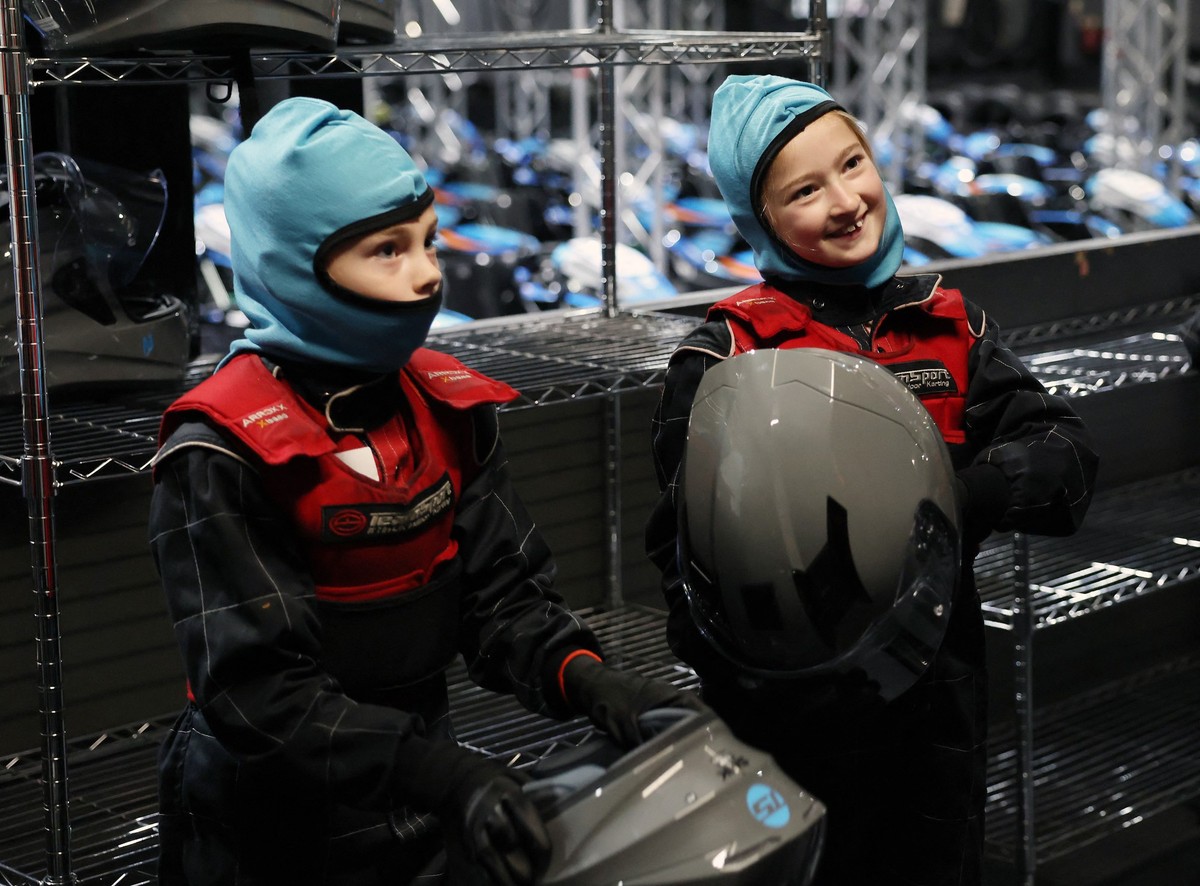 Girls react after a TeamSport Go Karting girl only taster session in Nottingham, central England on October 29, 2025. A dozen girls whizzed around an English karting track, part of a pioneering drive  ...
