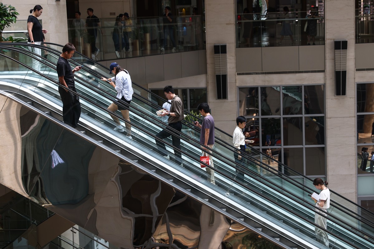 epa12230898 People take an escalator at a mall in Beijing, China, 11 July 2025. According to the United Nations Population Fund (UNFPA), China's population decreased to 1,416.1 millions in 2025,  ...
