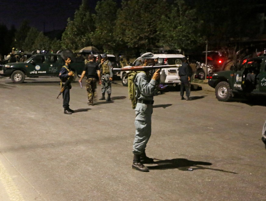 Afghan policemen stand guard at the site of an attack at American University of Afghanistan in Kabul, Afghanistan August 24, 2016. REUTERS/Omar Sobhani