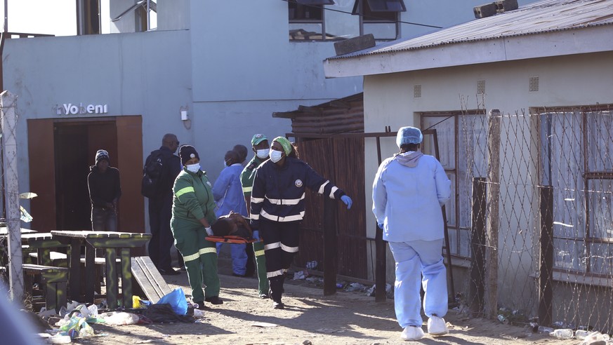 A body is removed from a nightclub in East London, South Africa, Sunday June 26, 2022. South African police are investigating the deaths of at least 20 people at a nightclub in the coastal town of Eas ...