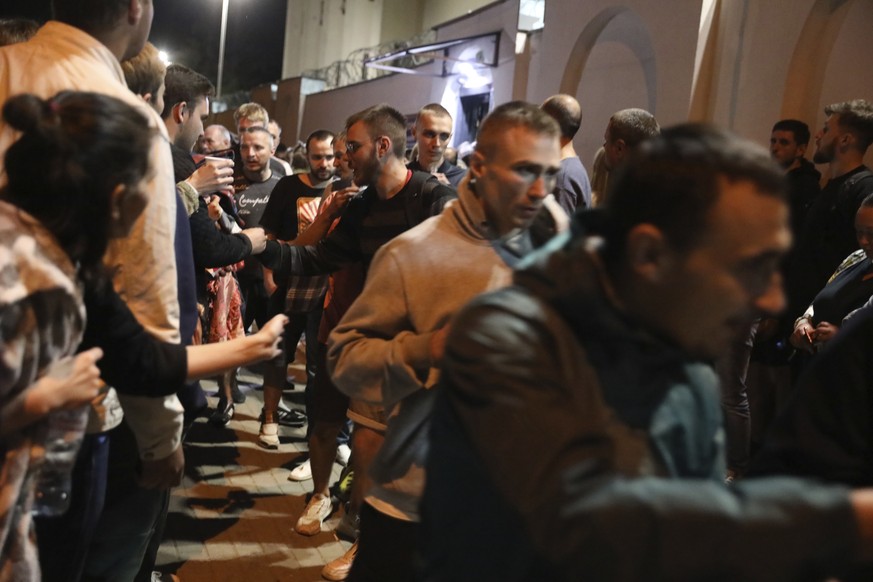 Relatives and friends greet people after being released from a detention center where protesters were detained during a mass rally following presidential election in Minsk, Belarus, Friday, Aug. 14, 2 ...