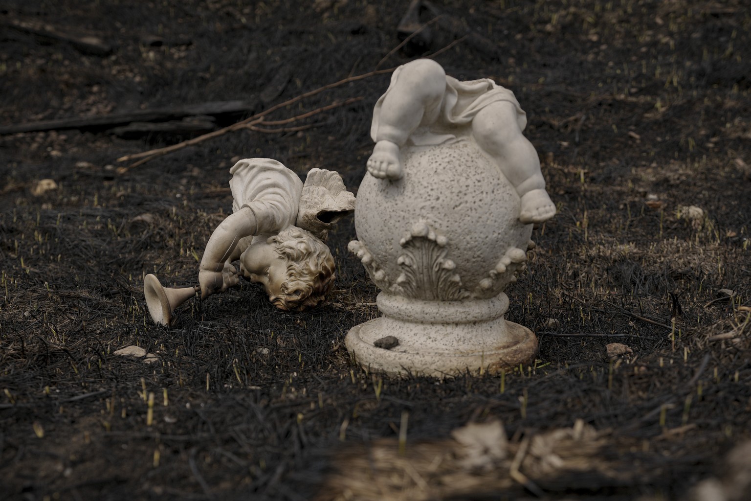 A broken garden decoration lies on a burned field close to an industrial facility used by Russian forces in Bucha, Ukraine, Monday, April 4, 2022. Russia faced a fresh wave of condemnation on Monday a ...