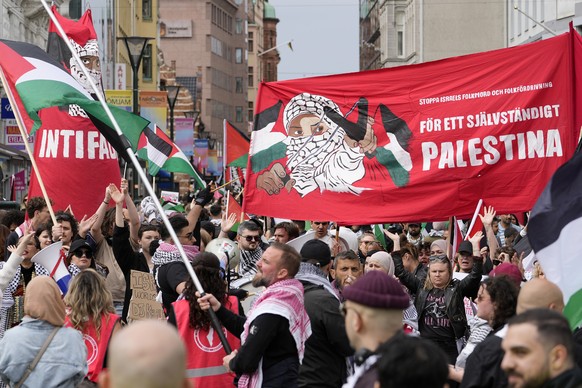 People carry a banner with the words in Swedish "For an independent Palestine" during a Pro-Palestinian demonstration for excluding Israel from Eurovision ahead of the second semi-final at t ...