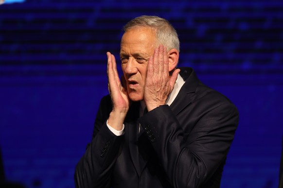 epa07495266 Benny Gantz, former Israeli army chief of staff and candidate for prime minister of the Blue and White Israeli centrist political party, gestures after giving a speech during a rally with  ...