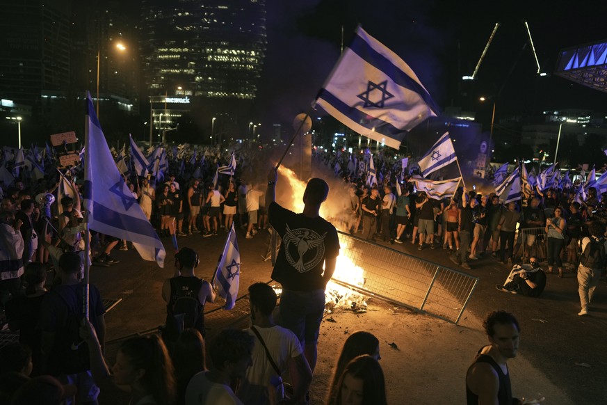 Demonstrators protest against plans by Prime Minister Benjamin Netanyahu&#039;s government to overhaul the judicial system, in Tel Aviv, Monday, July 24, 2023. Israeli lawmakers on Monday approved a k ...