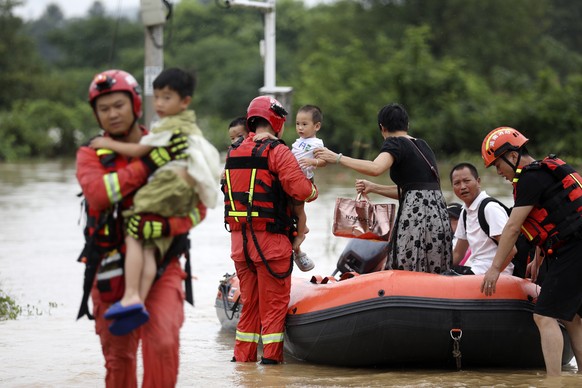 epa11502883 Rescuers relocate residents at Jingtang Village, Zixing, Hunan, China, 28 July 2024. The residual winds from Typhoon Gaemi continue to bring heavy rains to many places in Hunan Province, a ...