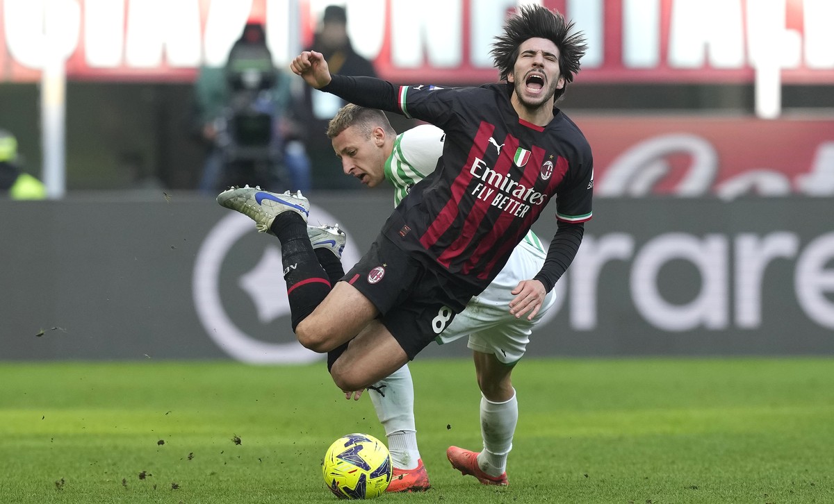 AC Milan's Sandro Tonali is fouled by Sassuolo's Davide Frattesi, during a Serie A soccer match between AC Milan and Sassuolo at the San Siro stadium in Milan, Italy, Sunday, Jan. 29, 2023.  ...