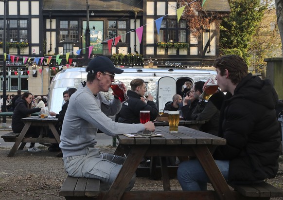 FILE - In this file photo dated Monday April 12, 2021, customers drink outside the Gregorian Pub in London as COVID-19 lockdown restrictions were further eased. The Office for National Statistics said ...
