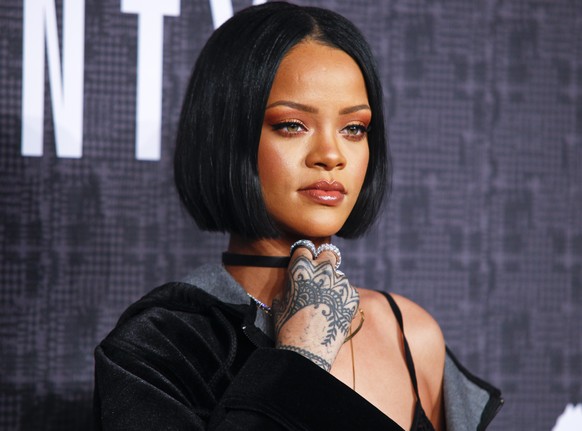 FILE - In this Feb. 12, 2016, file photo, Rihanna attends the JFENTY PUMA by Rihanna fashion show in New York. Rihanna will receive the Rock Star Award at the annual event honoring black women, BET an ...