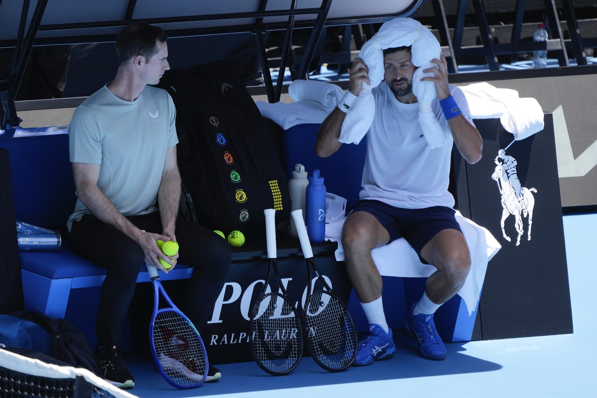 Serbia's Novak Djokovic talks with his coach Andy Murray, left, during a practice session ahead of the Australian Open tennis championship in Melbourne, Australia, Saturday, Jan. 11, 2025. (AP Ph ...