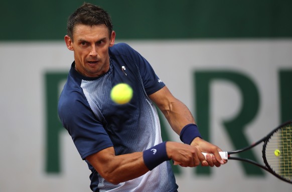 epa09970228 Henri Laaksonen of Switzerland plays Pedro Martinez of Spain in their men?s first round match during the French Open tennis tournament at Roland ?Garros in Paris, France, 23 May 2022. EPA/ ...