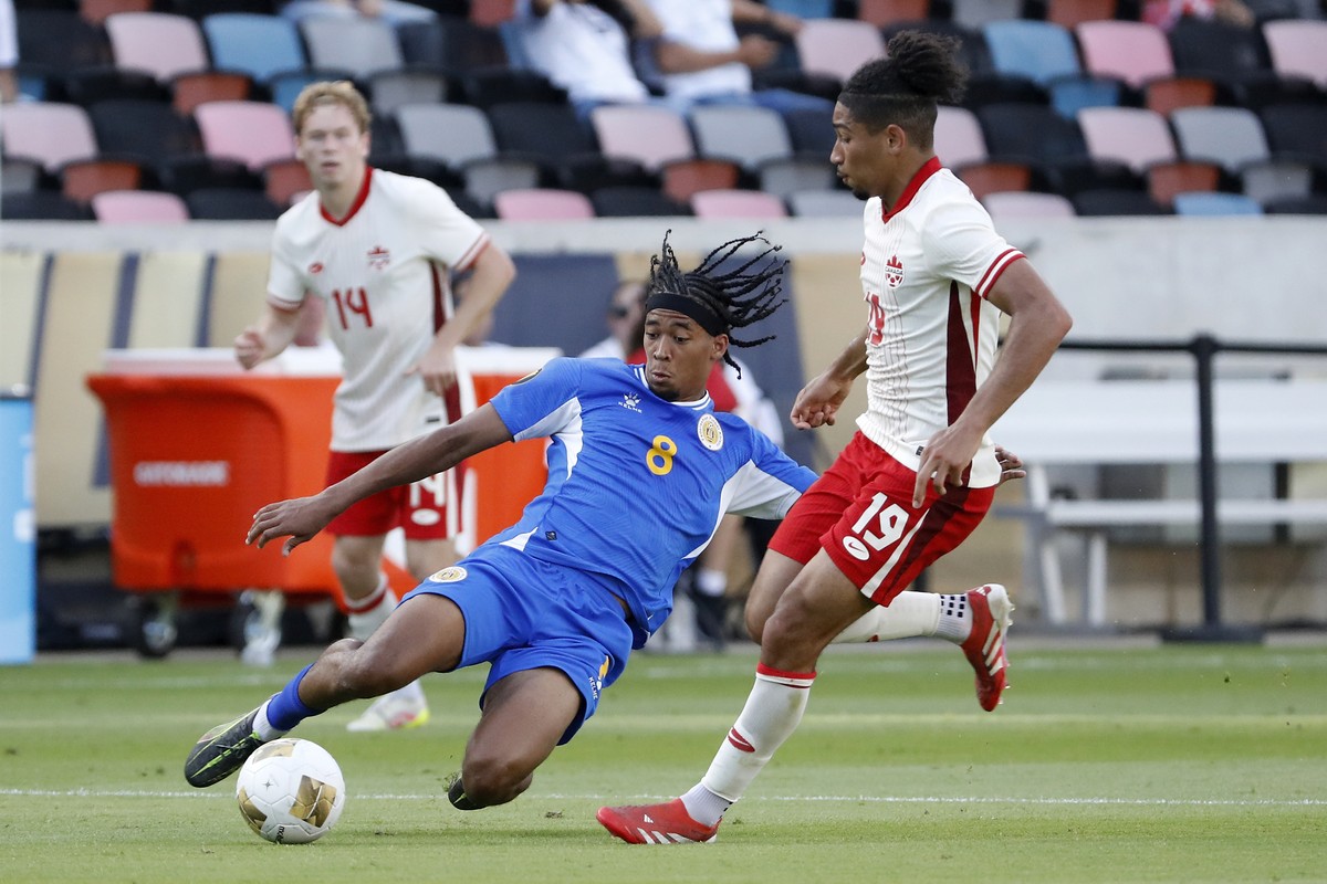 Curacao's Livano Comenencia (8) slide tackles the ball away from Canada's Nathan Saliba (19) during a CONCACAF Gold Cup soccer match Saturday, June 21, 2025, in Houston, Texas. (AP Photo/Mic ...